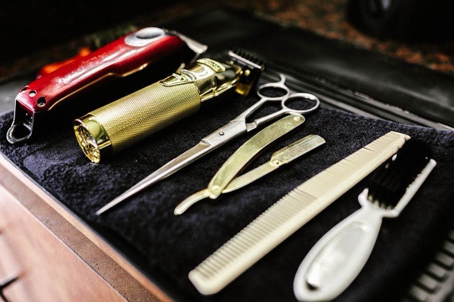 Barber tools: clippers, scissors, a razor, a comb and a brush