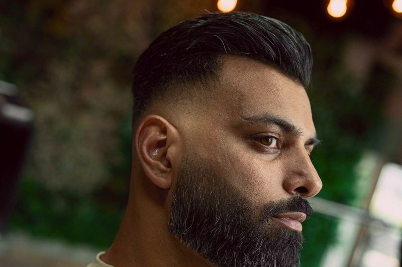 A full beard, shaped, with a fade